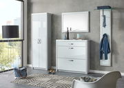 Moderne Garderobeneinrichtung mit weißem Schuhschrank, Spiegel und Garderobenpaneel in einem hellen Raum mit Blick aus dem Fenster.