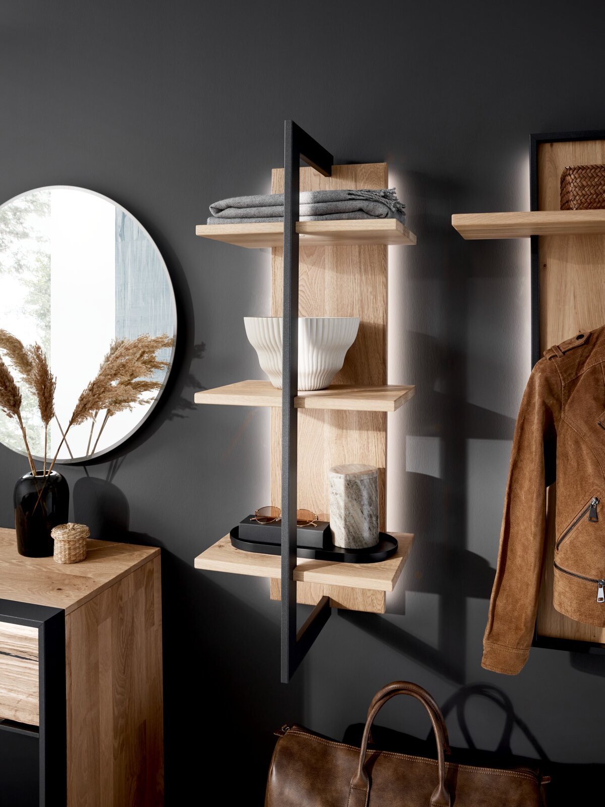 Modernes Wandregal aus Holz mit schwarzem Metallrahmen, seitliche Perspektive, dekoriert mit Schalen, Tüchern und Accessoires.