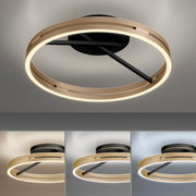 Moderne plafondlamp PURE Loop in de vorm van een gouden ring met een zwarte voet, gezien van onderaf.