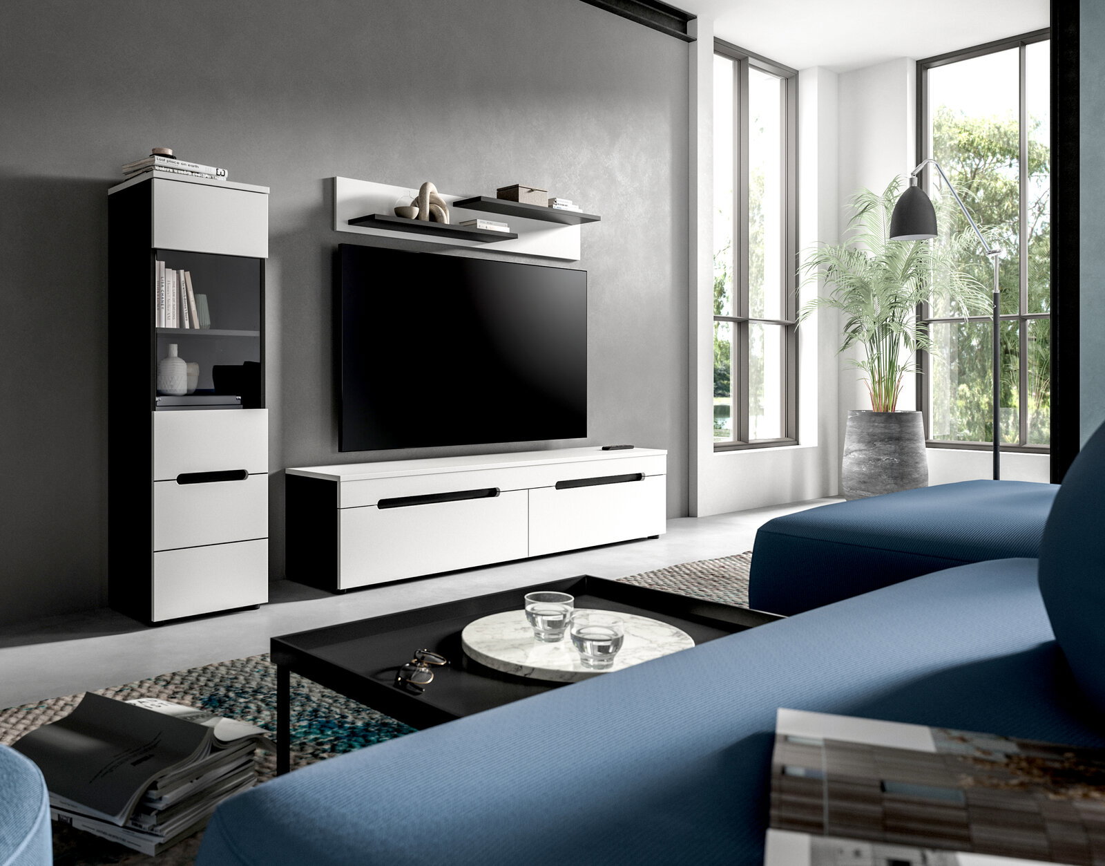 Modernes Wohnzimmer mit weißem TV-Lowboard und passendem Hochschrank, großem Flachbild-TV und Wandregal an grauer Wand, fotografiert aus schräger Frontansicht im hellen Raum mit großen Fenstern.
