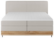 Boxspringbett in Frontalansicht mit hellgrauem Stoffbezug und Holzfußteil