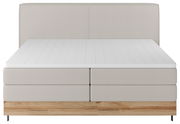Boxspringbett in Frontalansicht mit hellgrauem Stoffbezug und Holzfußteil