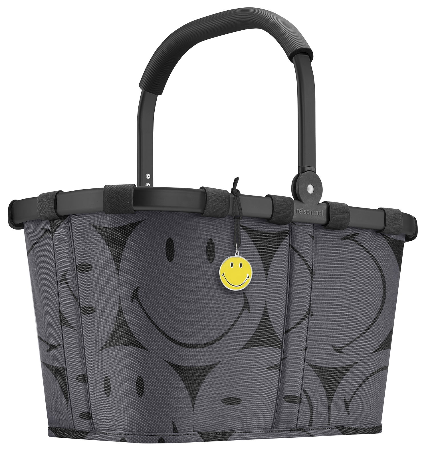 Reisenthel Carrybag Smiley Grey Grauer Einkaufskorb mit schwarzen Smiley-Motiven und einem gelben Smiley-Anhänger, seitliche Perspektive