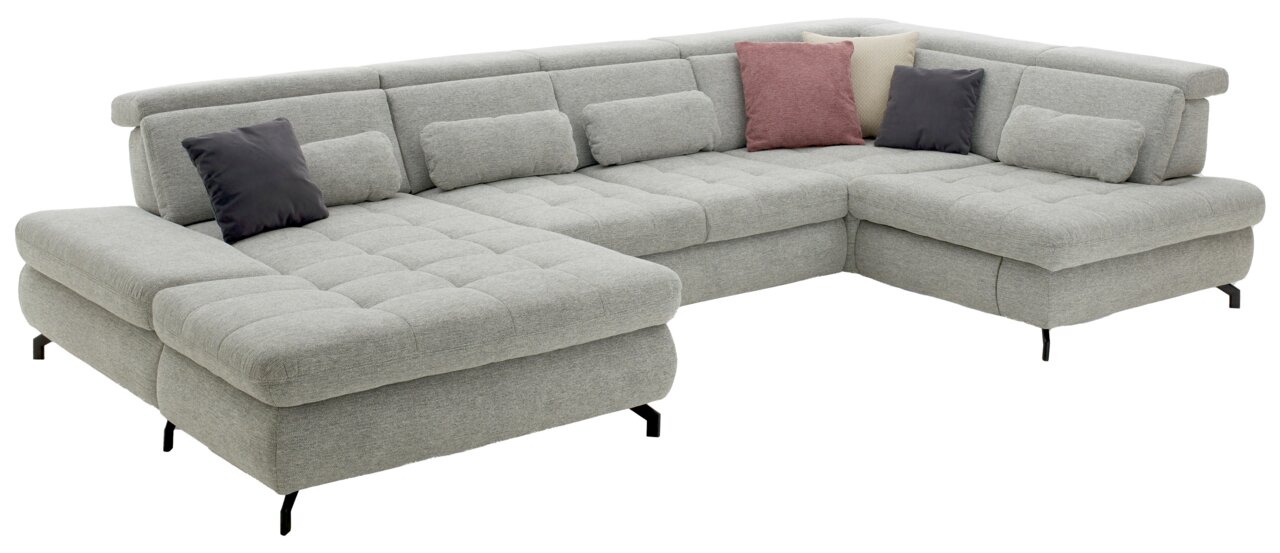 Graue Polsterrundecke mit mehreren Kissen, aus einer leicht erhöhten Perspektive fotografiert.