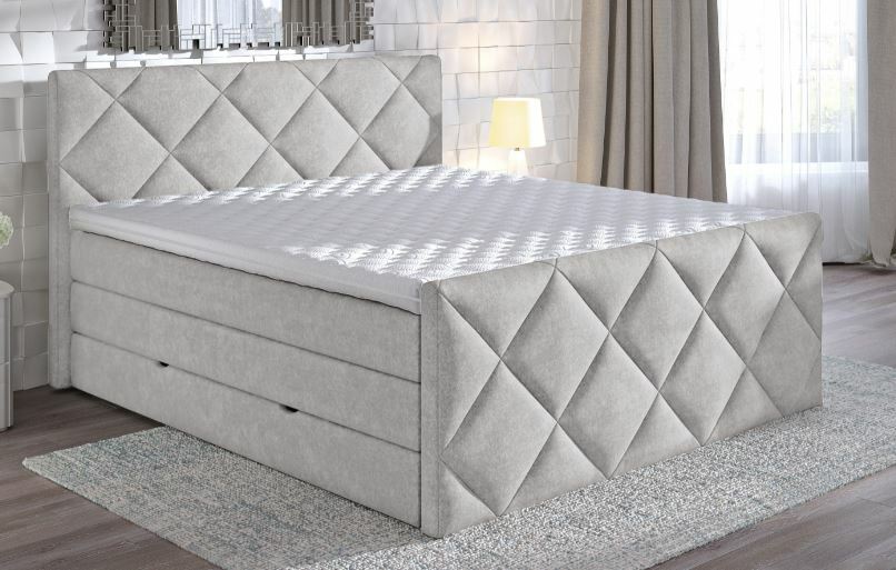 Boxspringbett SILVIA in grauem Stoff mit gestepptem Kopf- und Fußteil, seitliche Perspektive im modernen Schlafzimmer.