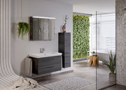 Moderne Badezimmeransicht mit einem hängenden Badblock in dunklem Holzton, Waschbecken mit Spiegel und grüner Pflanzenwand im Hintergrund, seitliche Perspektive.