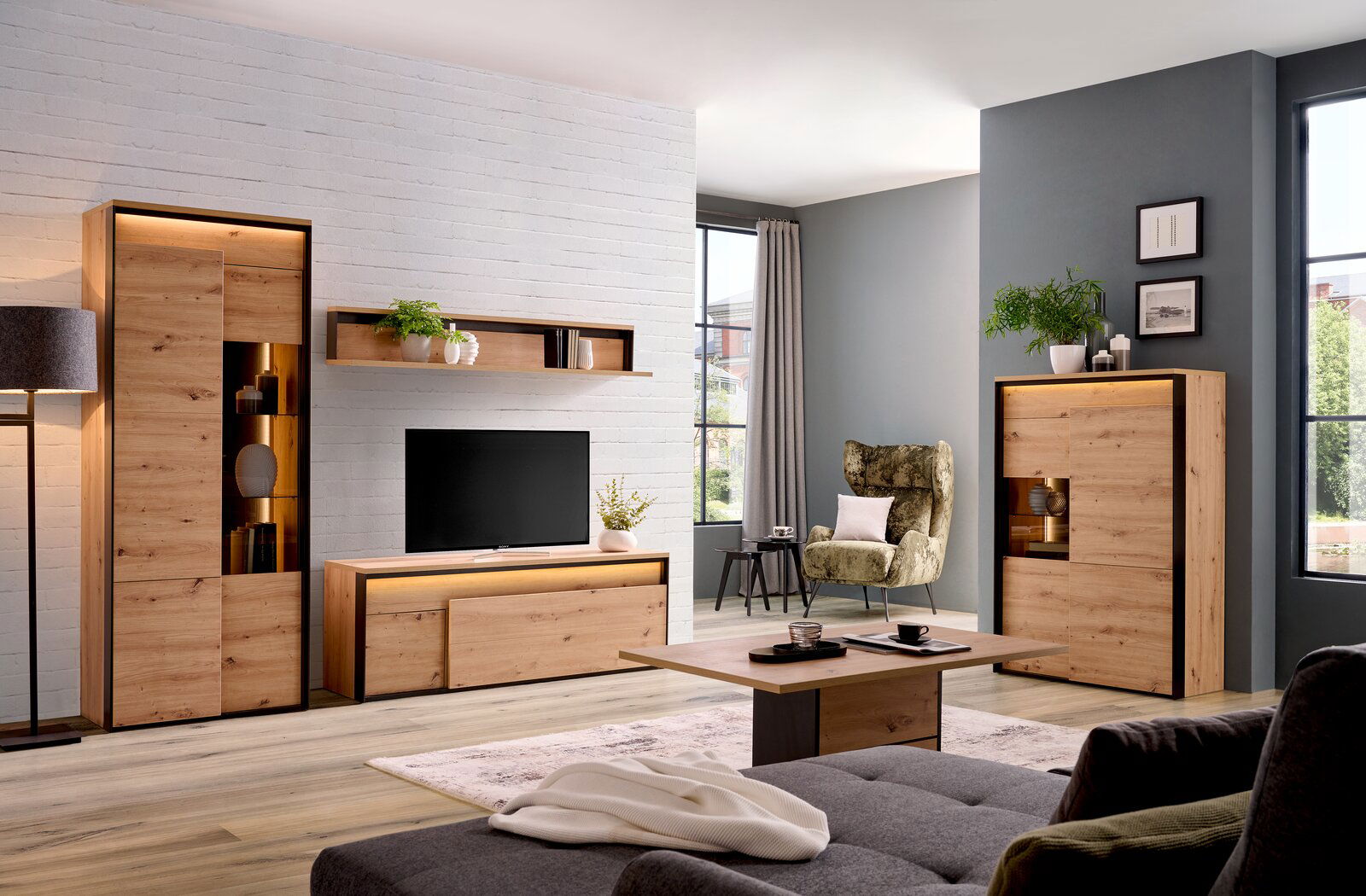 Hom´in Couchtisch Wohnzimmer mit modernen Holzmöbeln, darunter ein TV-Lowboard, ein Wandboard, ein Highboard und ein Couchtisch, aus einer frontalen Perspektive.
