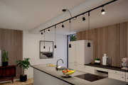 Moderne Küche mit stilvoller Beleuchtung aus der Deckenperspektive, inklusive Hängelampen und Schienensystem.