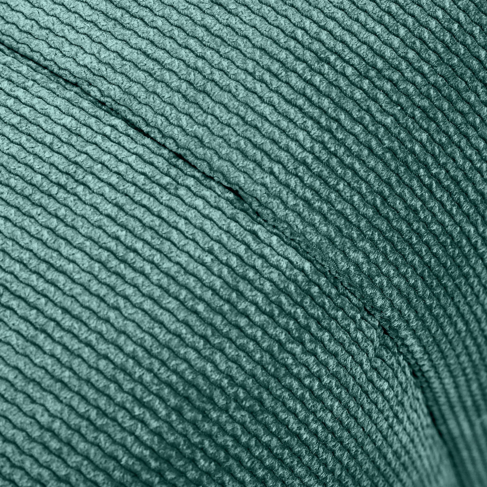 Nahaufnahme eines grünen, strukturierten Stoffes eines Hockers