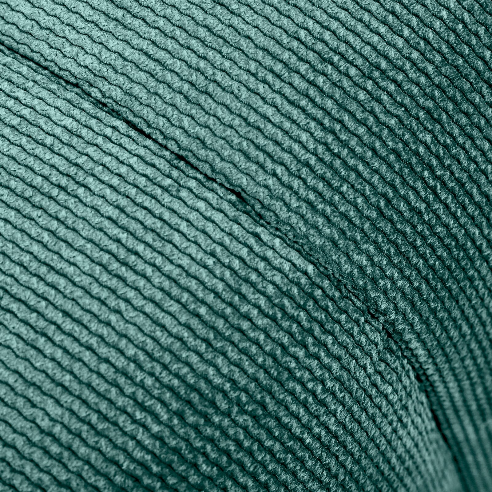 Nahaufnahme eines grünen, strukturierten Stoffes eines Hockers