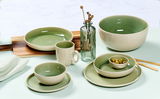 Frühstücksset in hellgrün und dunkelgrün mit Tassen, Schalen und Tellern, von oben betrachtet.