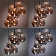 Moderne LED-Pendelleuchte mit mehreren kugelförmigen, rauchgrauen Glaskörpern, aus der Perspektive von unten betrachtet.