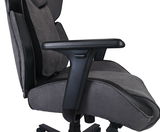 Seitliche Ansicht eines grauen Gaming Stuhls mit Armlehne und ergonomischer Rückenlehne.