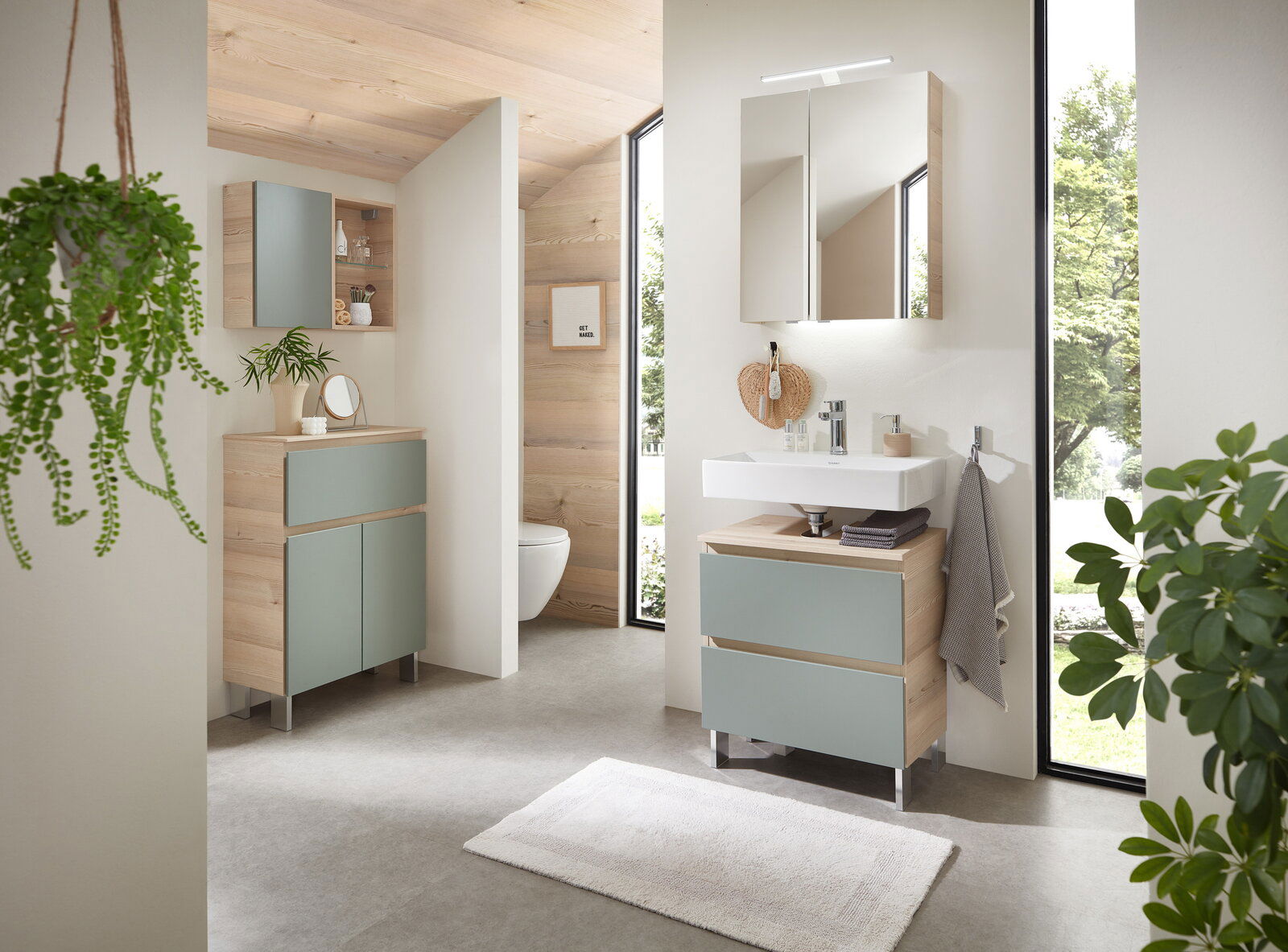 Sadena Waschbeckenunterschrank M-PLAN Moderner Waschbeckenunterschrank in Holzoptik mit zwei Schubladen in einem hellen Badezimmer, seitliche Perspektive