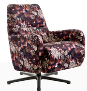 Blumig gemusterter Relaxsessel mit schwarzem Drehfuß, seitliche Perspektive