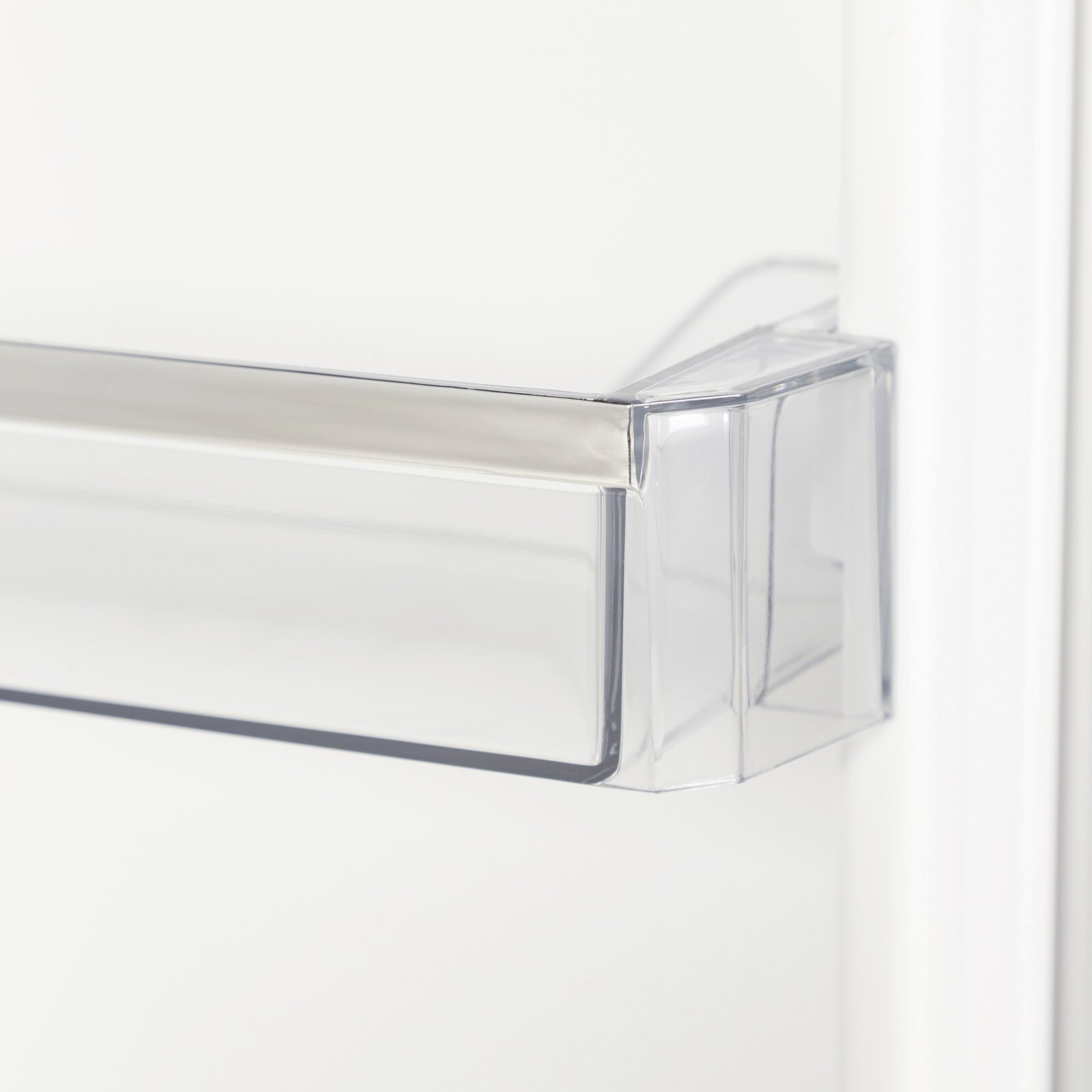 Detailaufnahme einer transparenten Kunststoff-Schublade/Schubladenfront (z. B. Kühlschrank-Schublade), gezeigt aus seitlicher Perspektive mit Fokus auf die vordere Ecke