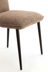 Nahaufnahme eines modernen Stuhls mit braunem Stoffbezug und schwarzen Metallbeinen, seitliche Perspektive.