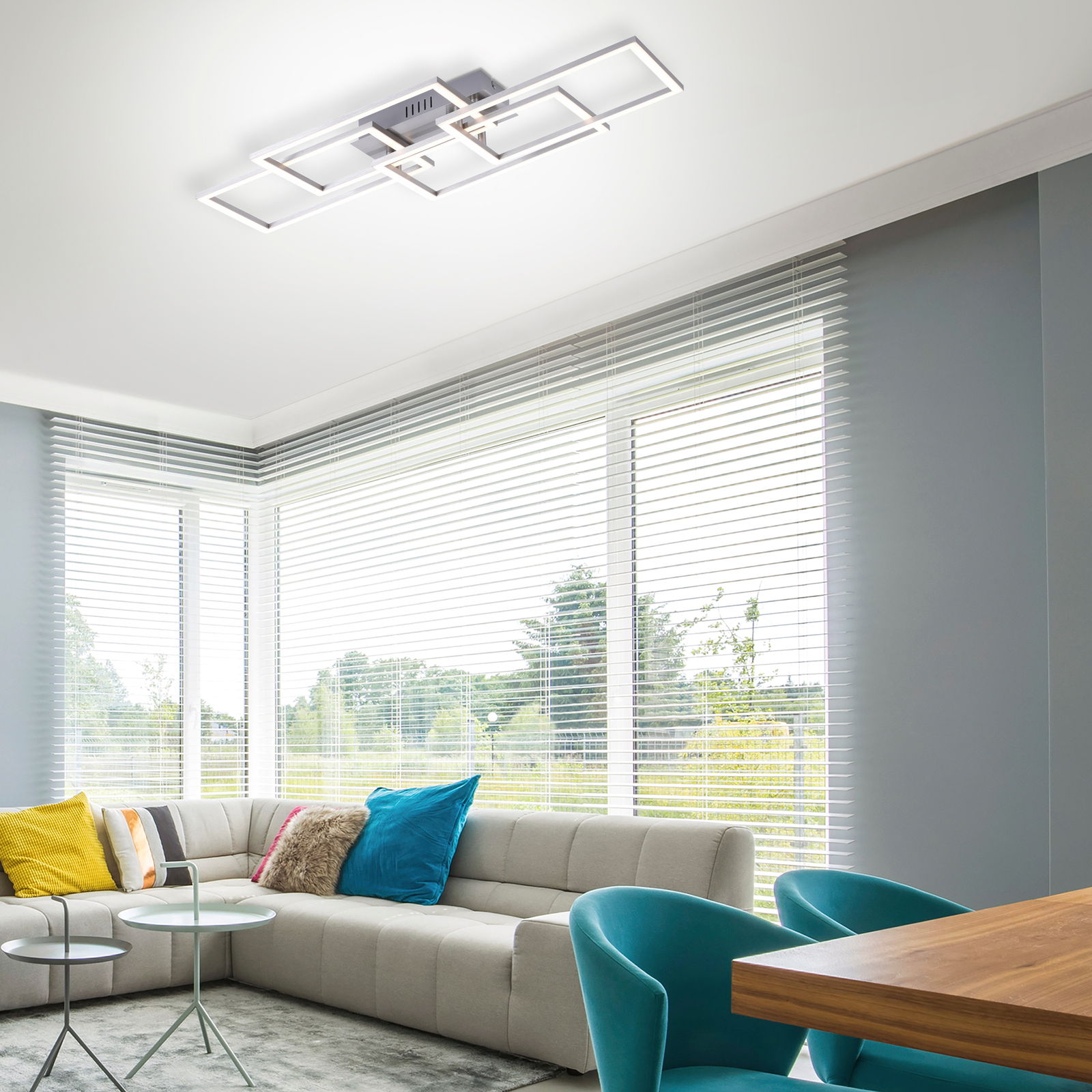 Moderne Deckenleuchte IVEN in geometrischem Design, von unten betrachtet in einem stilvollen Wohnzimmer mit großen Fenstern.