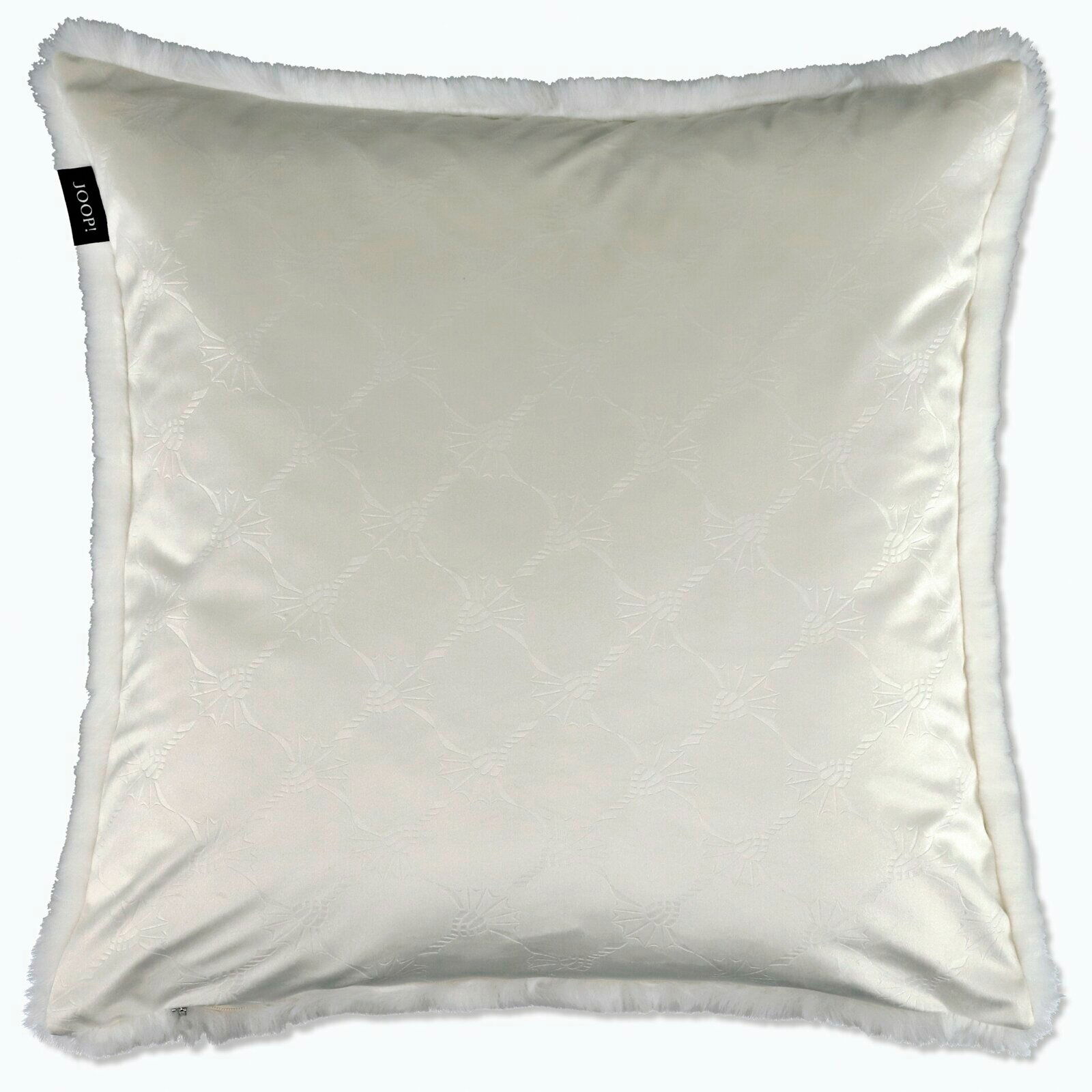 Weißes Kissen mit dezentem Muster und flauschigem Rand, von oben betrachtet.