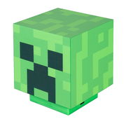 Grüne, würfelförmige Minecraft-Creeper-Lampe mit pixeligem Muster und Gesicht, schräg von vorne oben fotografiert.