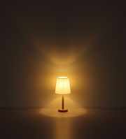 Stehleuchte mit warmem Licht, frontal betrachtet, auf einem dunklen Hintergrund.