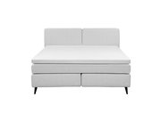 Frontale Ansicht eines modernen Boxspringbetts in hellem Grau mit schlichtem Design und schwarzen Füßen.