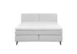 Frontale Ansicht eines modernen Boxspringbetts in hellem Grau mit schlichtem Design und schwarzen Füßen.
