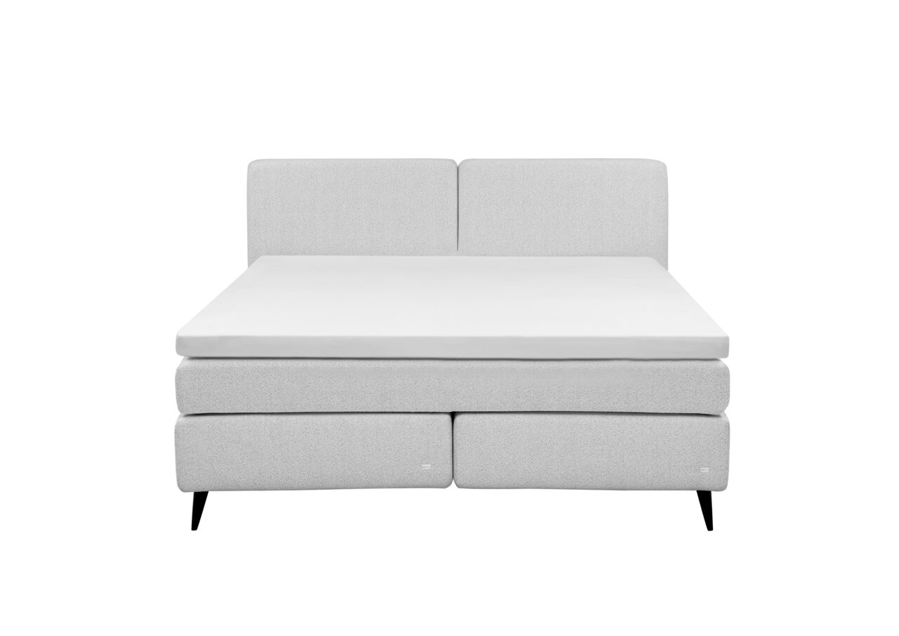 Frontale Ansicht eines modernen Boxspringbetts in hellem Grau mit schlichtem Design und schwarzen Füßen.