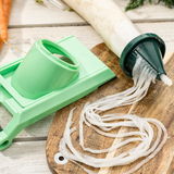 Nicer Dicer Chef 16-tlg. aus der Vogelperspektive, zeigt ein grünes Schneidegerät und geschnittenes Gemüse auf einem Holzbrett.