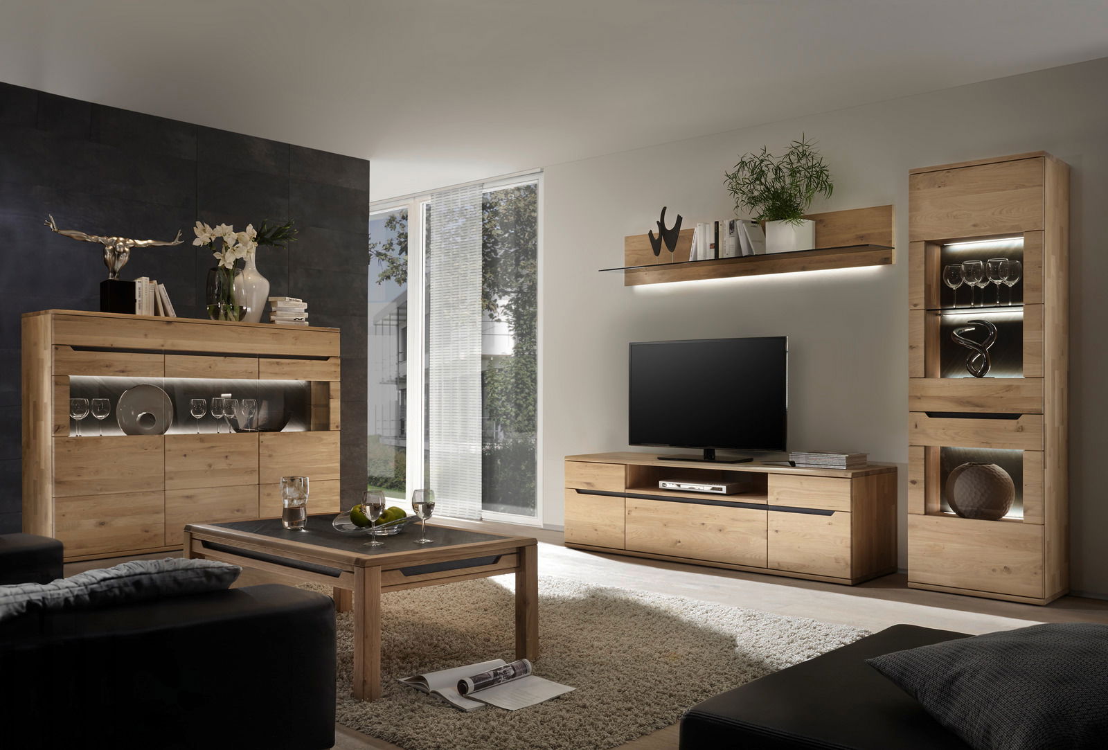 Moderne Wohnzimmer-Wandkombination aus Holz mit TV-Schrank, Regalen und Vitrine, seitliche Perspektive.