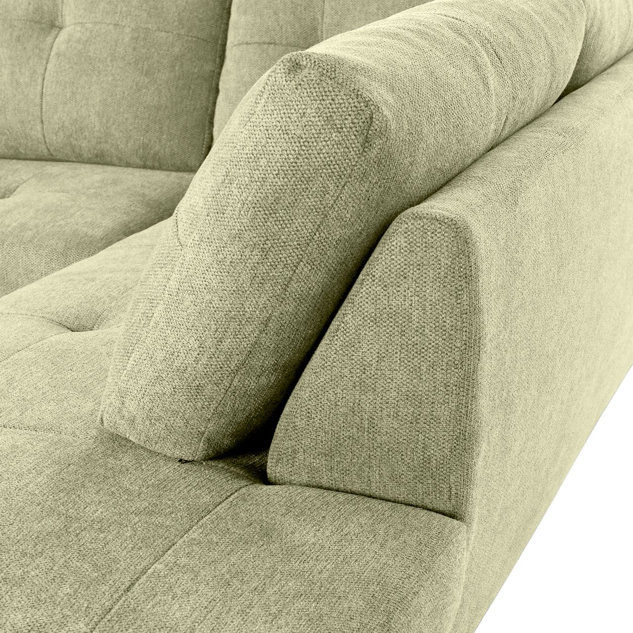 Nahaufnahme einer grünen Sofaecke mit Ottomane links, Perspektive von oben.
