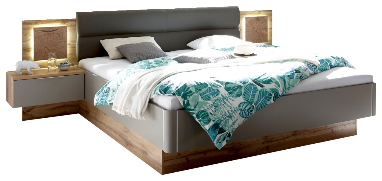 Bettanlage mit grauem Kopfteil, integrierter Beleuchtung und Nachttisch, aus Holz und grauem Material, Perspektive von schräg vorne