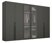Sechstüriger Drehtürenschrank in dunklem Design mit zwei Glastüren in der Mitte, die einen Blick auf hängende Kleidung und Regale mit gefalteten Textilien bieten. Frontalansicht.