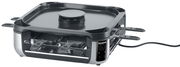 Smokeless Raclette-Grill von schräg vorne mit mehreren Pfännchen und glatter Grillplatte.