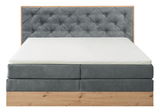 Boxspringbett mit grauem, gestepptem Kopfteil und Holzrahmen, Frontalansicht