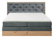 Boxspringbett mit grauem, gestepptem Kopfteil und Holzrahmen, Frontalansicht