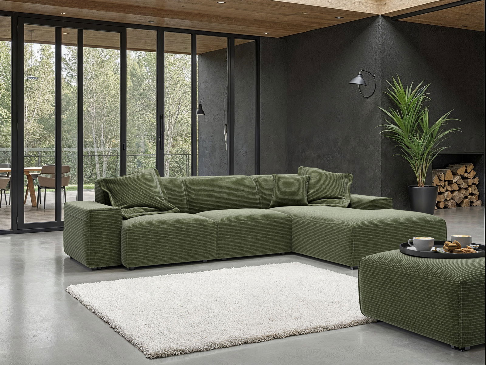 Grüne Rundecke (L) in modernem Wohnzimmer mit großen Fenstern, Blick von vorne.