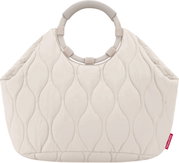 Gewatteerde handtas in crème/beige met een ovaal quiltpatroon en een rond handvat, productfoto van voren tegen een witte achtergrond