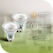 Twee transparante GU10-ledspots met warmwit licht van 3000 K en een levensduur van 50.000 uur, schuin van voren en licht van boven afgebeeld.