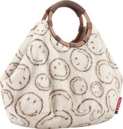 Flauschige Handtasche aus Teddyplüsch in Creme mit braunem Kreis-Muster und zwei runden Tragegriffen, frontal aus der Vorderansicht freigestellt auf weißem Hintergrund