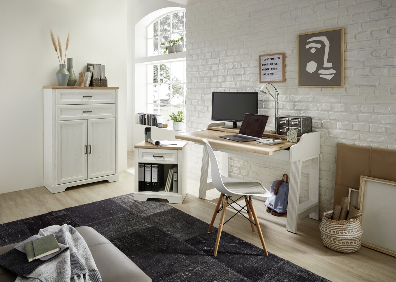 Helles, modernes Büro mit weißem Schreibtisch, Rollcontainer und Aktenschrank in einer gemütlichen Ecke mit natürlichem Licht.