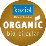 Rundes Logo mit der Aufschrift 'koziol Made in Germany ORGANIC bio-circular' in goldener Farbe, Vorderansicht.