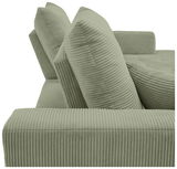 Nahaufnahme einer grünen, gerippten Sofaecke mit zwei großen Kissen, seitliche Perspektive.