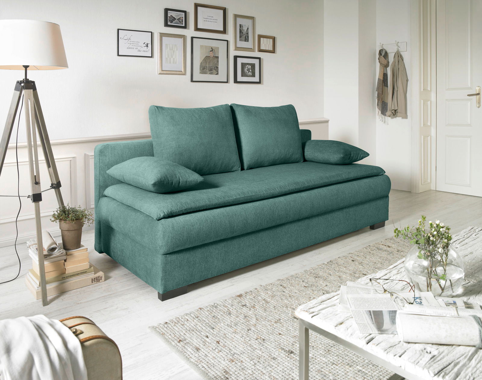 Grünes Funktionssofa in einem stilvoll eingerichteten Wohnzimmer, seitliche Perspektive