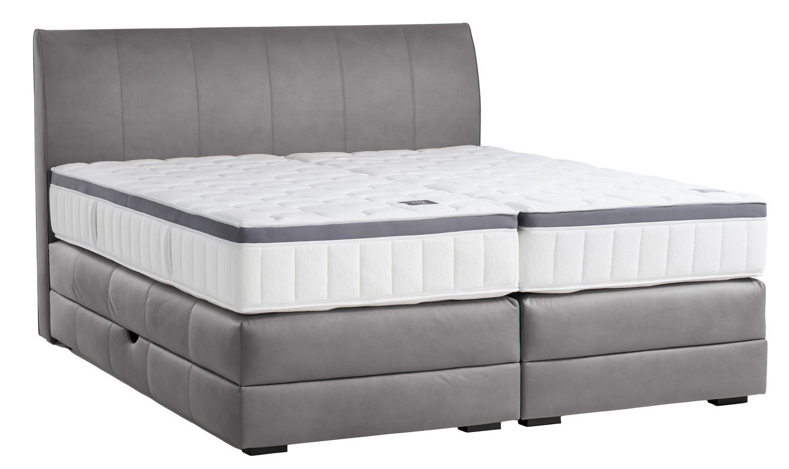 Boxspringbett in seitlicher Perspektive mit grauem Polster und weißer Matratze