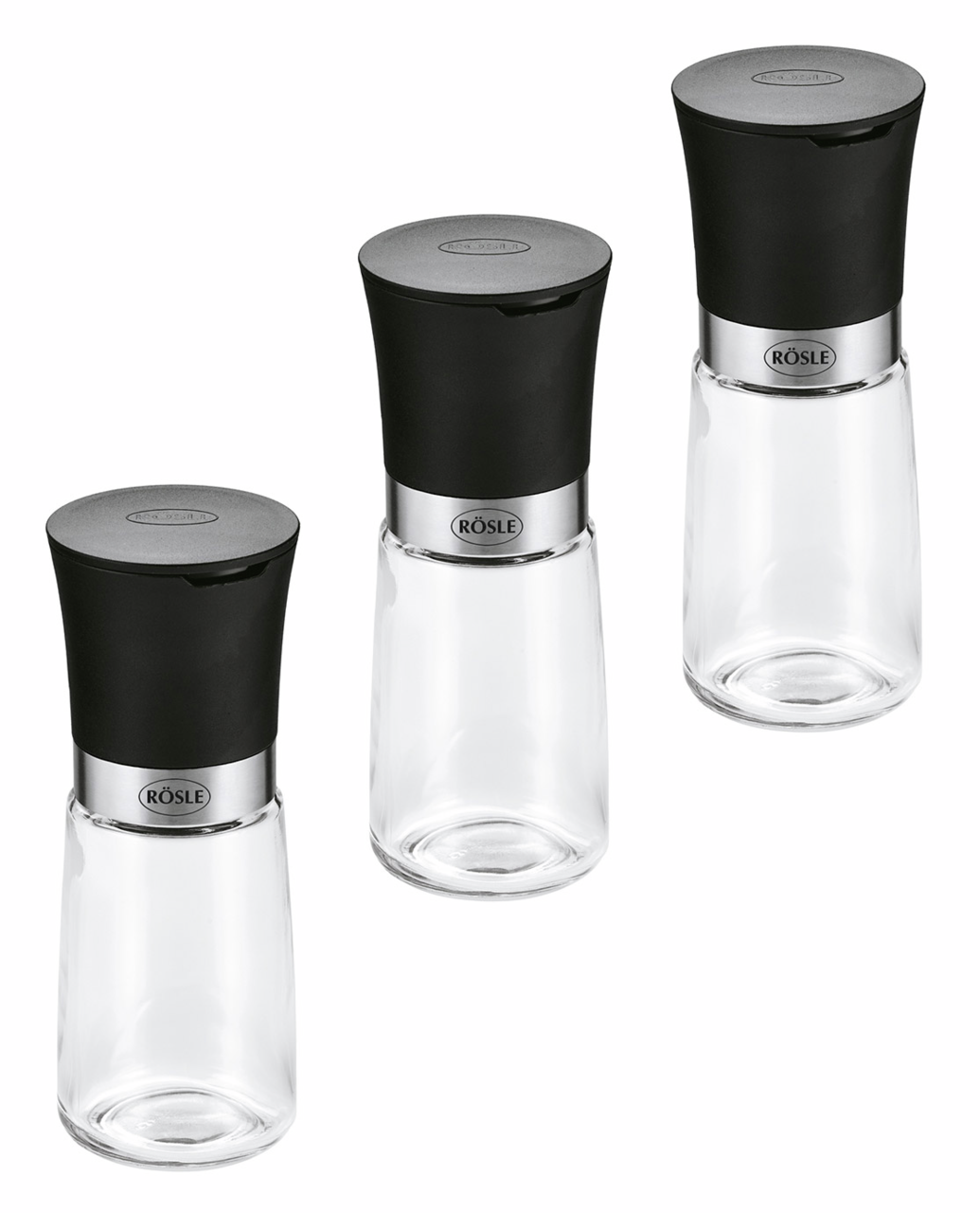 Dreiteiliges Gewürzmühlen-Set mit schwarzem Deckel und transparentem Glasbehälter, aus der Vogelperspektive fotografiert.