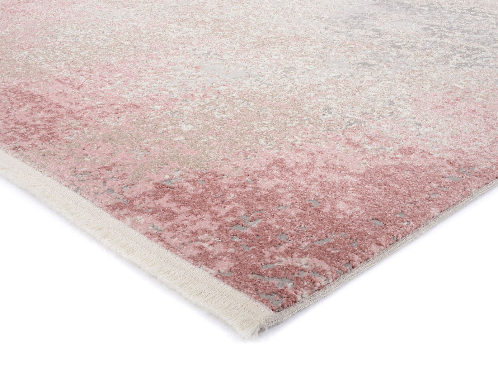 Designer Teppich in Rosa- und Beigetönen mit Fransen, perspektivisch von der Seite aufgenommen.