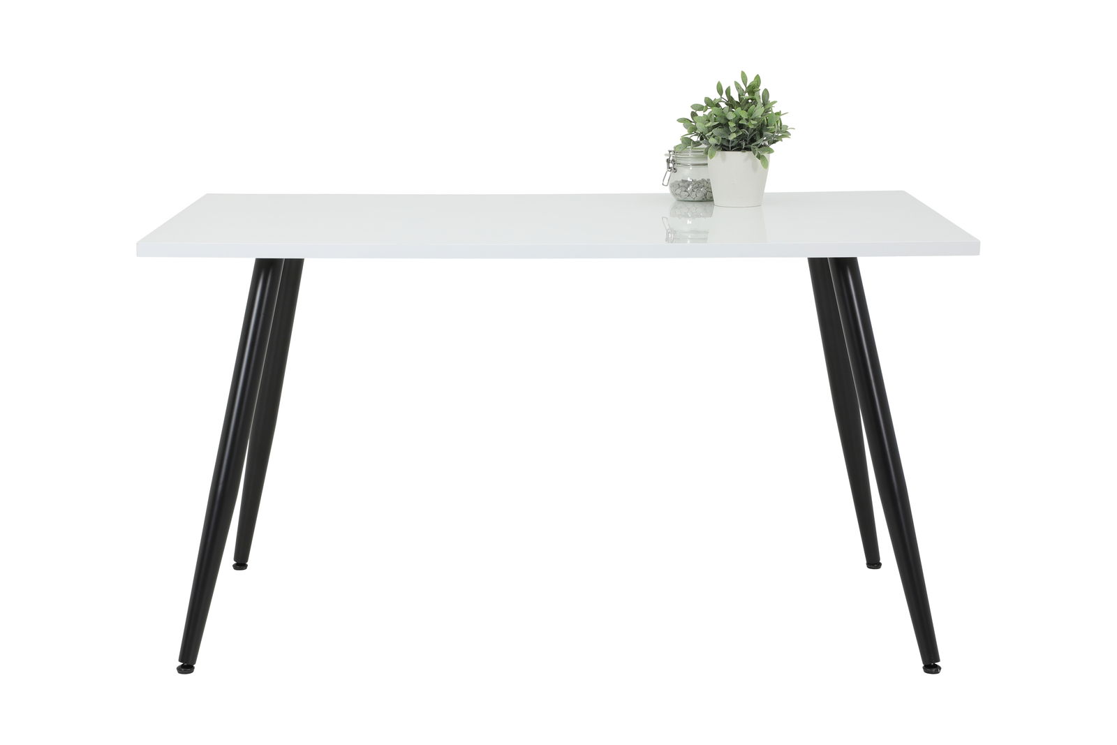 Z2 Esstisch ANIKA Moderner weißer Esstisch mit schwarzen Beinen, frontal fotografiert, mit einer Pflanze und einem Glasgefäß als Dekoration.
