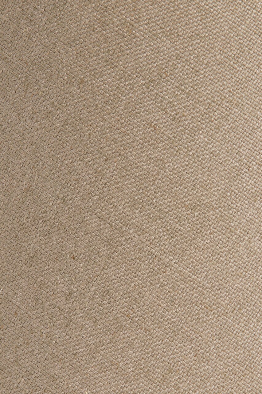 Nahaufnahme eines beigen, gewebten Lampenschirms mit texturierter Oberfläche.