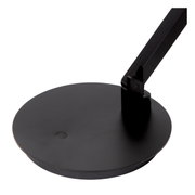 Nahaufnahme der Basis einer schwarzen Tisch- oder Schreibtischleuchte mit modernem Design, von oben betrachtet.